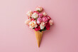 Waffle cone with rose blossoms inside, pink background