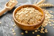 Top view of wooden bowl filled with oats rolled oats and oat flakes representing healthy eating lifestyle dieting and vegetarian food