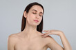 © New Africa - Portrait of beautiful young woman on light grey background