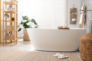 Sticker - Set of different bath accessories and soap on tub in bathroom