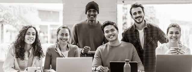 Wall Mural - Horizontal banner or header with smiling multiethnic coworkers looking at camera making team picture in modern office together - Diverse work group or department laugh posing for photo at workplace