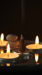 Wall Mural - An incense cone surrounded by candles and generating smoke.