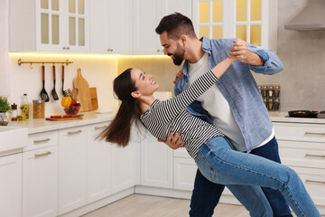 Poster - Happy lovely couple dancing together in kitchen