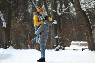 Sticker - Beautiful happy couple outdoors on winter day. Space for text