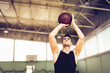 © Marko Geber - Man shooting basketball in indoor gym