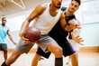 © Marko Geber - Young men playing basketball in a indoor gym