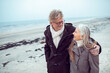 © Marko Geber - Senior couple walking on the beach at winter