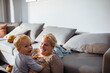 © Davor - Mother playing with her toddler in the living room