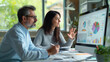 © Studio Nova - Two professionals are engaged in a discussion over a computer displaying colorful analytical graphs, suggesting a collaborative business meeting or data review session.