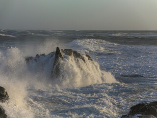 Wall Mural - Small cape being hit by strong stormy sea waves