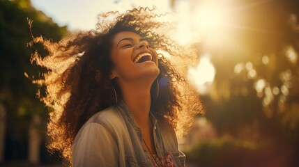 Wall Mural - A stylish young woman, laughing joyfully in an urban park