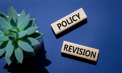 Sticker - Policy revision symbol. Concept word Policy revision on wooden blocks. Beautiful deep blue background with succulent plant. Business and Policy revision concept. Copy space