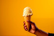 male hand holding vanilla ice cream cone, copy space, space for text