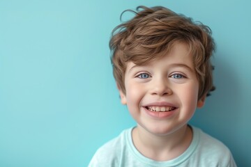 Wall Mural - Portrait of 10 years old boy with beautiful face on blue background