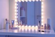 © Alina - Makeup dressing table with large mirror in modern bedroom interior. Light bulbs