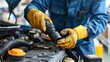 Skilled and confident male auto mechanic expertly working in a professional car service workshop.
