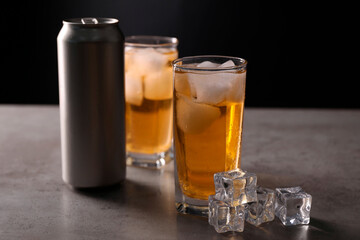 Wall Mural - Energy drink in glasses, aluminium can and ice cubes on grey table