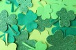 canvas print picture - St. Patrick's day. Decorative clover leaves on green background, top view