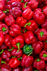 Wall Mural - Closeup of ripe red and green bell peppers on the farmer's market