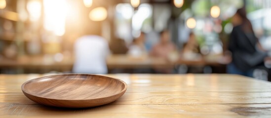 Sticker - A round wooden dish sits on a polished hardwood table. The empty plate awaits a delicious cuisine at the upcoming event