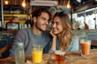 Cheerful couple having a casual conversation over beers in an urban cafe setting