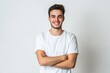 © Yulia - Portrait of smiling handsome man in white t-shirt, standing with crossed arms isolated on gray background
