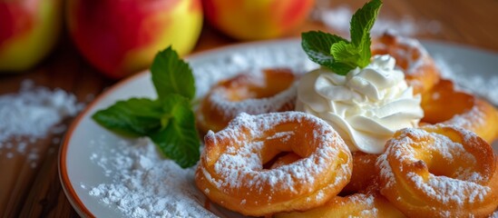 Canvas Print - a plate of apple donuts with whipped cream and mint leaves . High quality