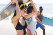 © WavebreakMediaMicro - Diverse friends, a group of young adults, enjoy a sunny beach day, with copy space