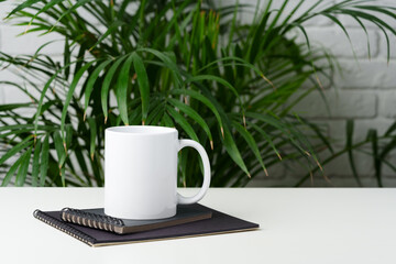 Wall Mural - Coffee mug on table against brick wall