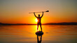 © GAmedia - A young man is sailing on a quiet lake on a SUP board at sunset. A beautiful golden sunset. Active recreation of a person in nature.