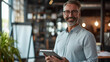 © Postproduction - Confident entrepreneur holding tablet in modern office space. Professionalism and technology.