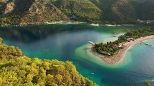 Aerial Drone Video Of Tropical Paradise Exotic Island Bay Covered In Limestone Trees With Emerald Crystal Clear Beach Visited By Luxury Yachts And Sail Boats. Dream Trip To Green Island