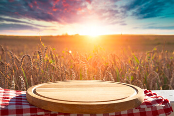 Wall Mural - Wooden Plank Empty Table For Products Display With Blurred Wheat Field and Blue Sky Background. High quality photo