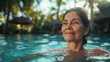 Mature adult woman, relaxing swimming in the swimming pool on a tropical island with palm trees at the hotel or villa