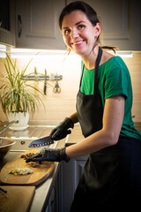 Woman cooking tasty melted chocolate on table in kitchen.