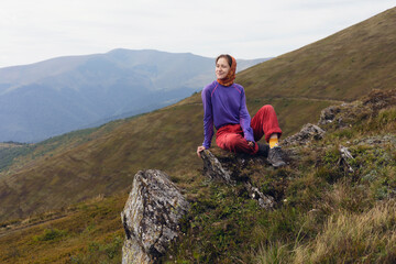 Wall Mural - girl tourist on the background of a mountain landscape