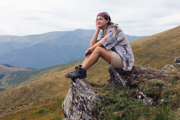 Wall Mural - girl tourist on the background of a mountain landscape