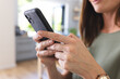 © Wavebreak Media - A young Caucasian woman is focused on using her smartphone