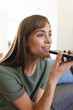 © Wavebreak Media - A middle-aged Caucasian woman is using voice command on her smartphone