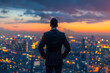 © mediahain.de - Rear view of a man in a suit looking out over the city at dusk