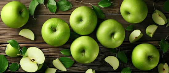 Poster - Fresh green apples with leaves on rustic wooden surface, organic fruit concept