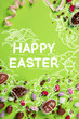 Leinwandbild Motiv Easter poster and banner template with text, chocolate eggs and drawings against green background. Creative holiday flyer. Template for banner, poster, postcards and greeting cards, ad