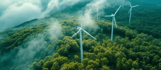 Wall Mural - Majestic wind turbines scattered throughout lush green forest landscape