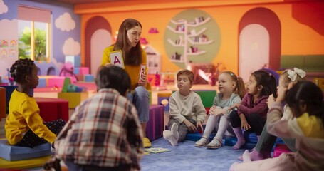 Wall Mural - Happy Kindergarten Pedagogue Having a Conversation with Kids, Using Enthusiastic Teaching Methods in a Modern Colorful Kindergarten. Female Educator Stimulating Linguistic and Social Skills 