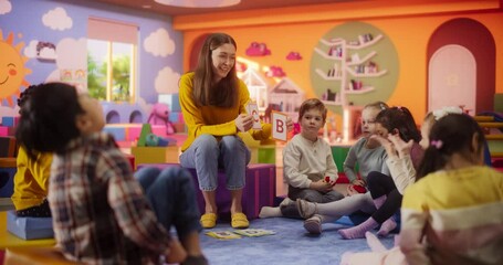 Wall Mural - Beautiful Daycare Teacher Learning Alphabet with Young Talented Kids. Female Educator Supervising Diverse Group of Children, Developing Their Knowledge Level for Elementary School