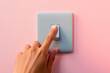 © Saga Heylin - woman's finger pressing a switch on the wall