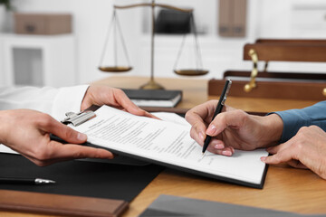 Sticker - Senior woman signing document in lawyer's office, closeup