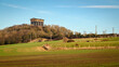 Penshaw Monument above cultivated field. Penshaw Monument is a copy of the Greek Temple of Hephaestus in Athens. Erected in 1844 the folly stands 20 metres high and dominates the skyline of Wearside