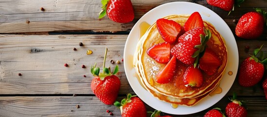 Wall Mural - Delicious strawberry pancakes on a wooden background.