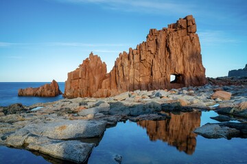 Sticker - view of the red rocks of Arbatax with reflections in tidal pools in the foreground